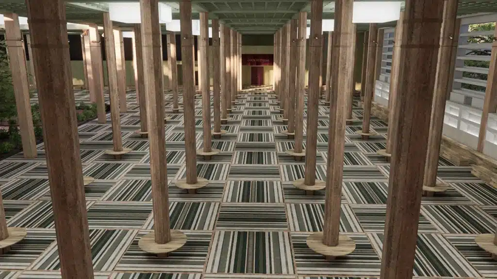 Le défilé Chanel à Dakar, présenté dans l’ancien Palais de Justice, mettait en scène un décor grandiose où l’architecture brutaliste du lieu dialoguait avec des références culturelles sénégalaises. La vaste salle, rythmée par des rangées de piliers monumentaux, formait une perspective sculpturale guidant le regard vers l’entrée solennelle du tribunal. Au sol, un tapis aux motifs graphiques tissés, inspiré des savoir-faire africains, apportait chaleur et texture. La lumière douce et contrôlée révélait la patine du bâtiment, transformant ce lieu institutionnel en un espace poétique, rituel et vibrant, hommage à la création et au dialogue entre Paris et Dakar.